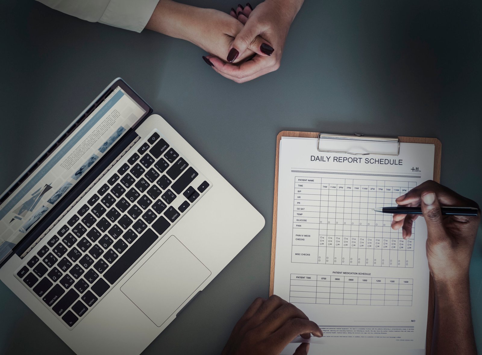 aerial view of doctor writing patient daily report checklist