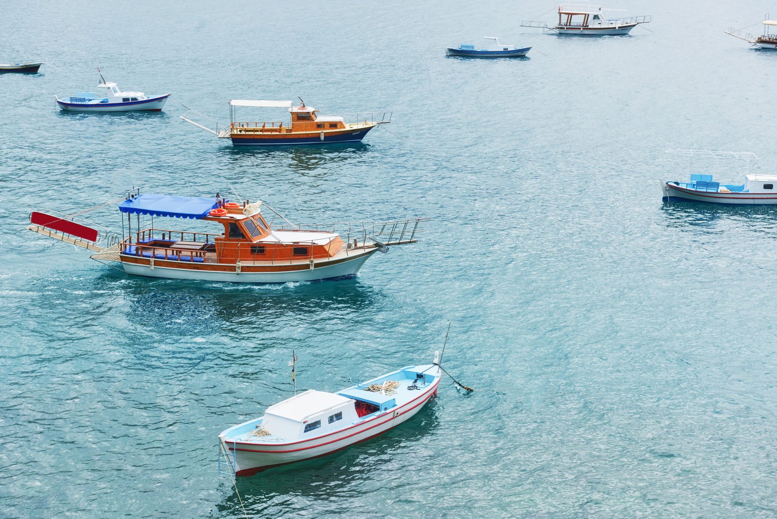 boats float in the calm blue sea water in turkey